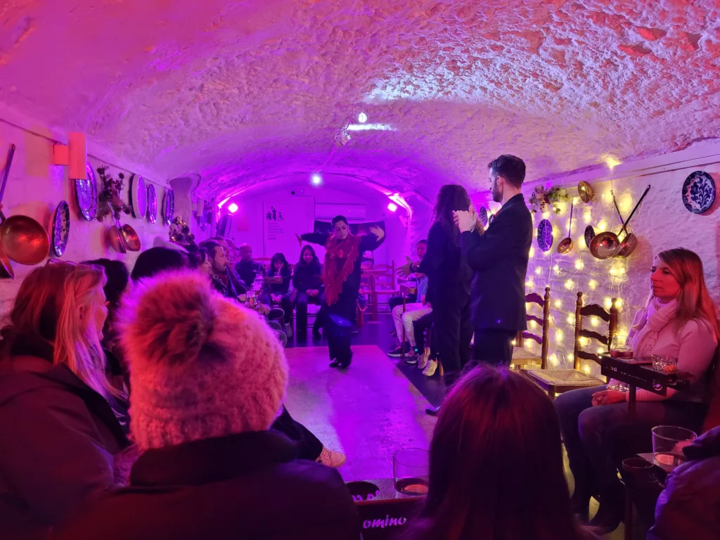 photo shows flamenco show in Granada Spain with dancer dancing in distance