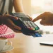 A photo of a customer making a selection on a credit card machine at a coffee shop