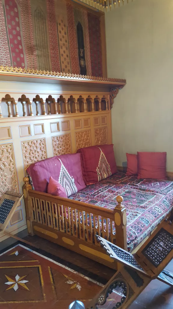 photo of a colorful sofa in oriental style blankets inside the oriental smoking room of Oberhofen Castle in Switzerland