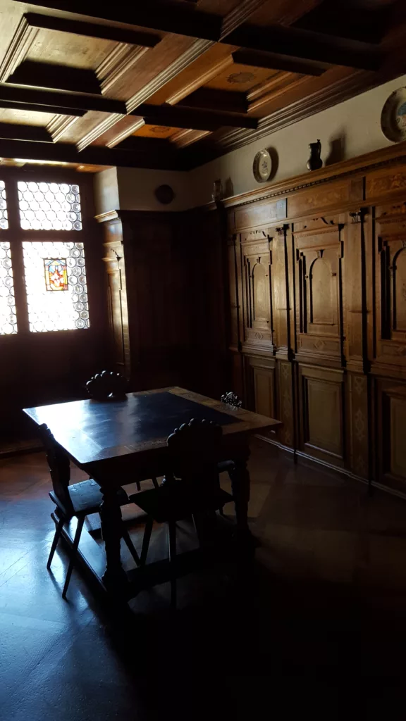 dark lit room showing wood furnishings inside Oberhofen Castle in Switzerland