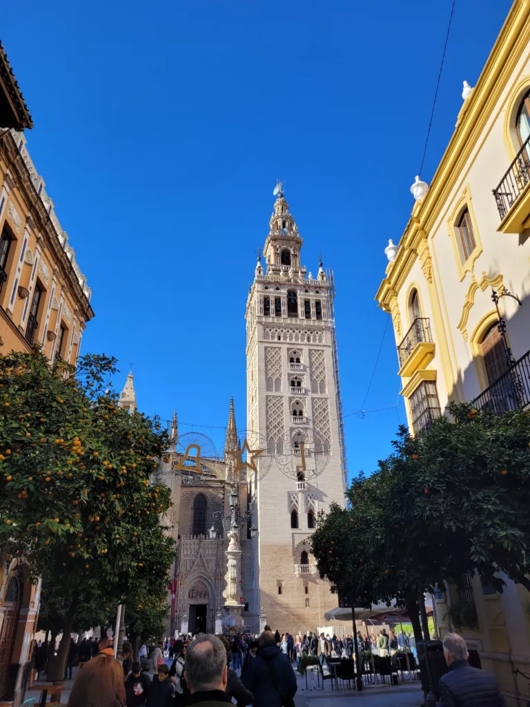 Photo of Giralda Tower at end of a street