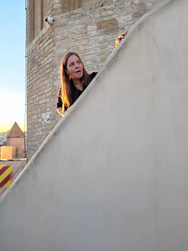 Photo of woman climbing up to the entrance of the naval museum at Torre del Oro in Seville