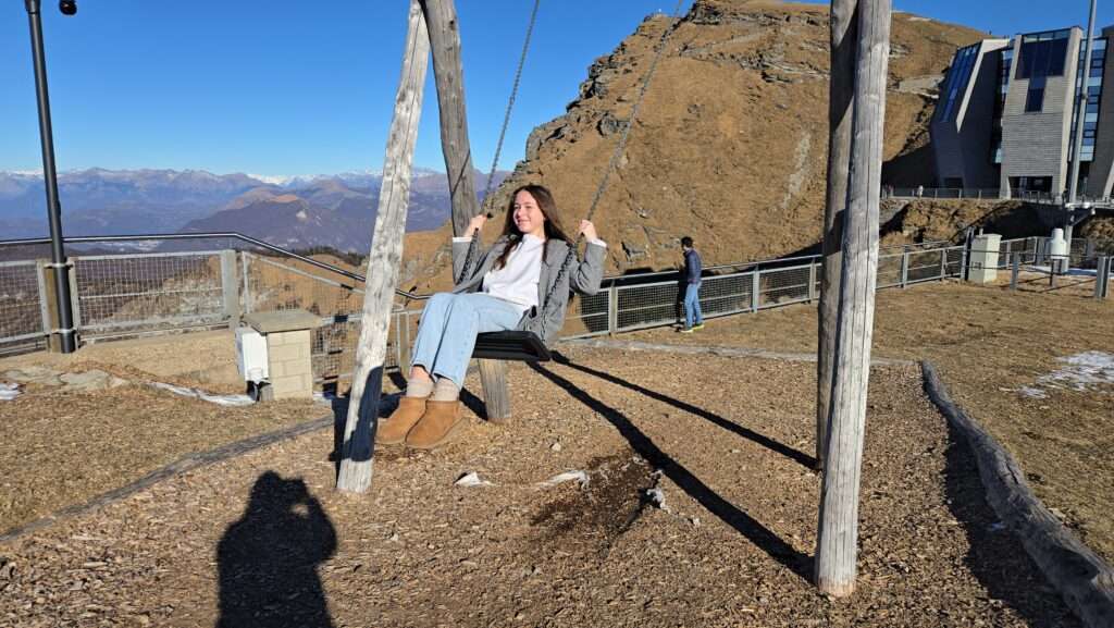 Girl swinging on swing at top of Monte Generoso summit