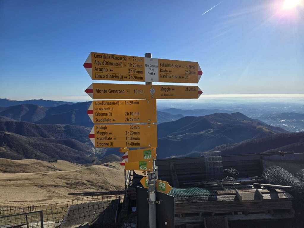 Walking path marker for various trails intersecting atop Monte Generoso summit